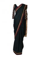 AW16S3- A black satin georgette saree that drapes beautifully to flatter any figure. It has a woven gold and maroon satin border and a black and gold brocade panel on the pallu. Comes with a pre-stitched black jersey blouse with matching brocade sleeves